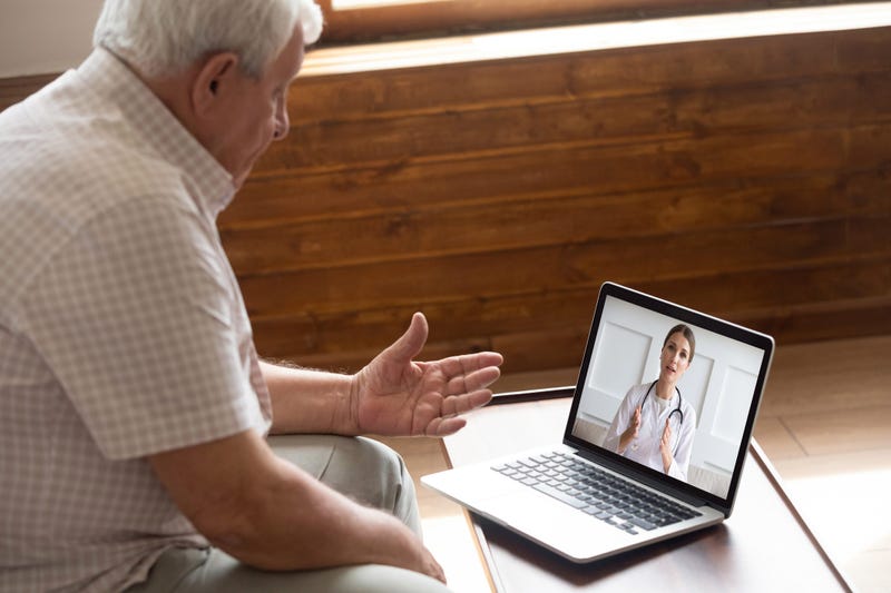 Elderly man using telemedicine