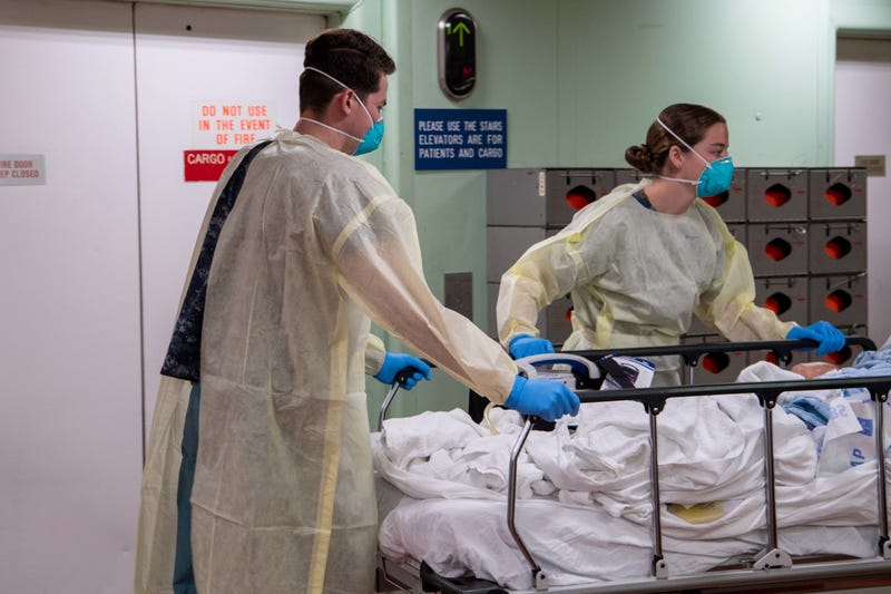 OS ANGELES, CA - MARCH 29: In this handout released by the U.S. Navy, Sailors transport the first patient aboard the hospital ship USNS Mercy (T-AH 19) into the casualty receiving area March 29.