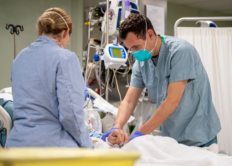 OS ANGELES, CA - APRIL 04: In this handout released by the U.S. Navy, Lt. Wade Miller, from Orlando, Fla., treats a patient aboard the hospital ship USNS Mercy (T-AH 19), April 4, 2020.