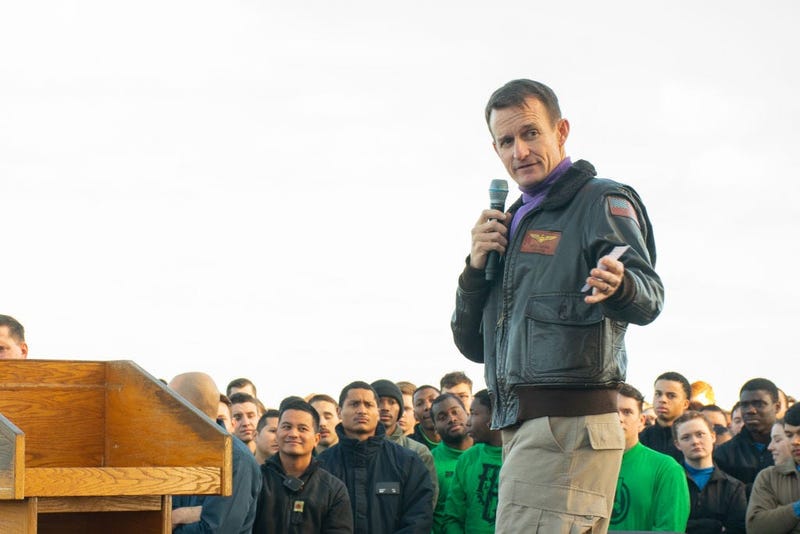 In this handout released by the U.S. Navy, Capt. Brett Crozier, commanding officer of the aircraft carrier USS Theodore Roosevelt (CVN 71), gives remarks during an all-hands call on the ships flight deck Dec. 15, 2019.
