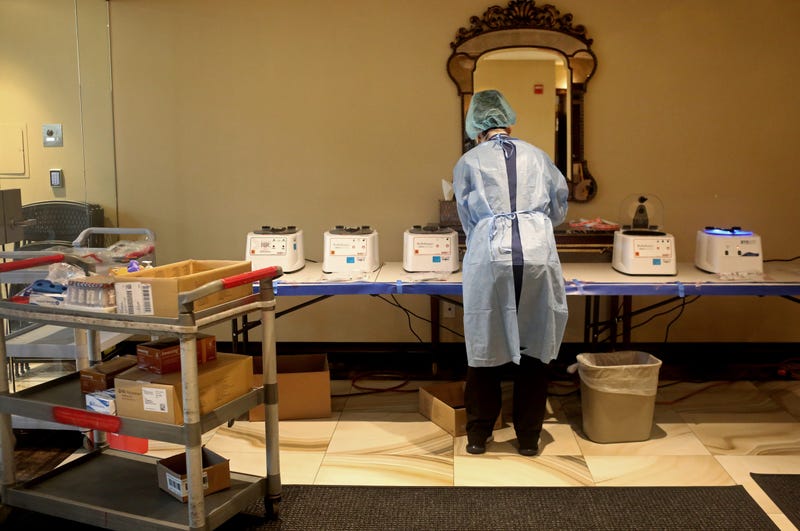 SPRING VALLEY, NY - APRIL 24: A phlebotomist processes specimens of people getting tested for coronavirus antibodies at the Refuah Health Center on April 24, 2020 in Spring Valley, New York.