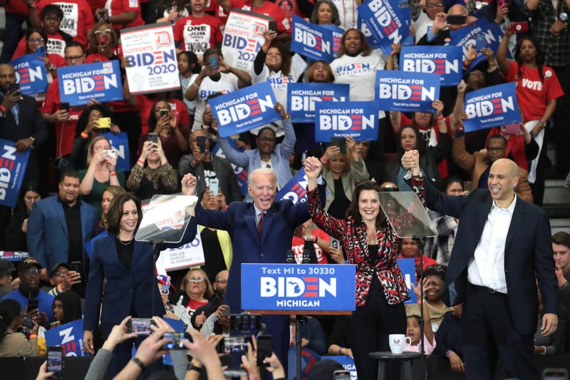 Sen. Kamala Harris (L) (D-CA), Sen. Cory Booker (R)(D-NJ), and Michigan Governor Gretchen Whitmer join Democratic presidential candidate former Vice President Joe Biden on stage at a campaign rally at Renaissance High School on March 09, 2020 in Detroit.