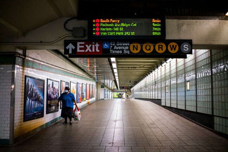 A woman walks inside the Times Square subway station before the new nightly closures on May 5, 2020 in New York City.