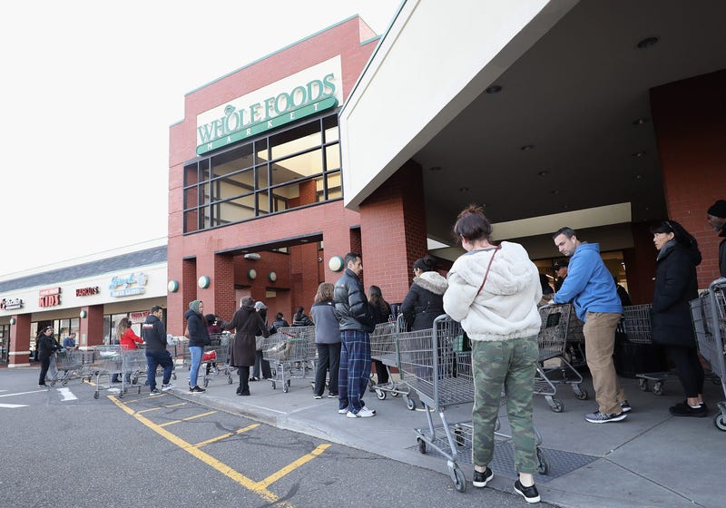 Customers wait for the opening of Whole Foods on March 18, 2020 in Jericho, New York.