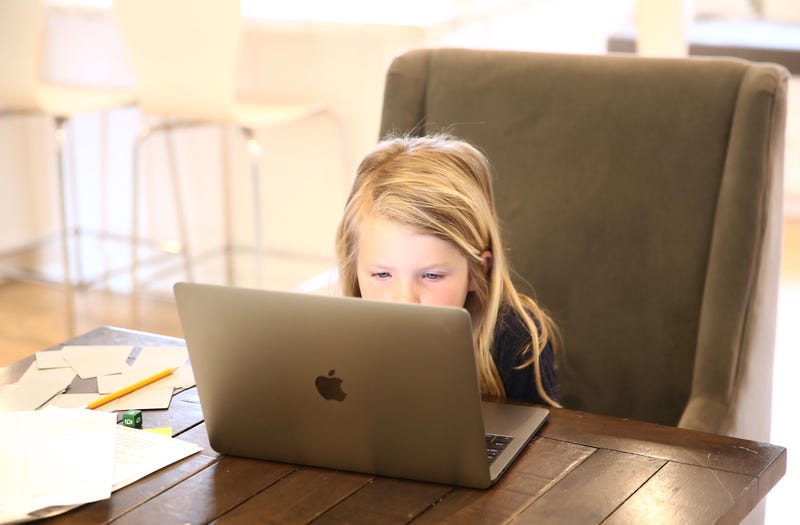 Evianna Van Santvoord, who is in kindergarten, does her schoolwork at home on March 18, 2020 in San Anselmo, California.