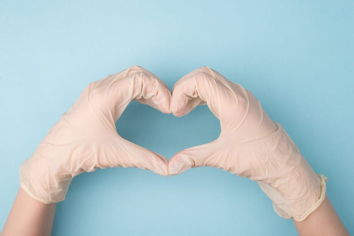 Gloved hands making a heart sign