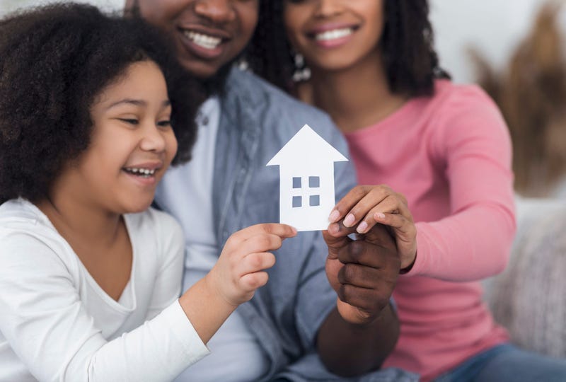 Stay At Home And Family Housing Concept. Cutout Paper House In Hands Of Little Girl Her Parents,