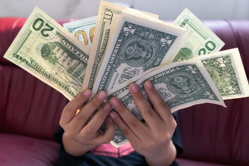 Dollar money banknote in young boy hand.Freelance Business making money and Internet shopping online concept