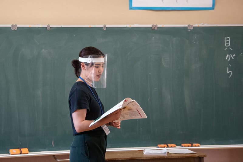 A teacher wearing a plastic face visor teaches a class at Kinugawa Elementary School on June 3, 2020 in Nikko, Japan.