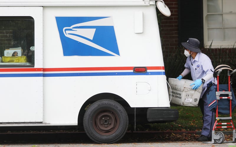A U.S. Postal Service (USPS) worker wears a mask and gloves amidst the coronavirus pandemic on April 13, 2020 in Santa Monica, California.