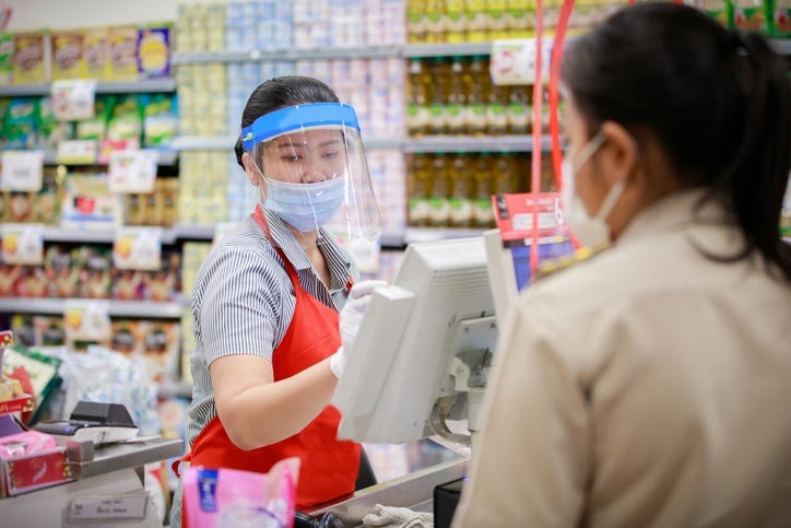 supermarket cashier in medical protective mask