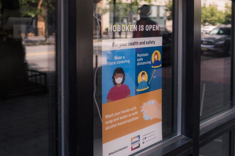 A sign reading Hoboken Is Open is displayed in the window as the city reopens from the coronavirus lockdown on June 15, 2020 in Hoboken, New Jersey.