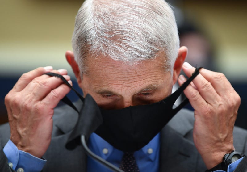 Dr. Anthony Fauci, director of the National Institute of Allergy and Infectious Diseases, takes off his face mask before testifying at a hearing of the U.S. House Committee on Energy and Commerce on Capitol Hill on June 23, 2020 in Washington, DC.