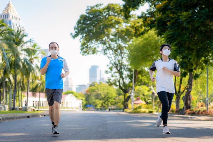 Two people jogging outside