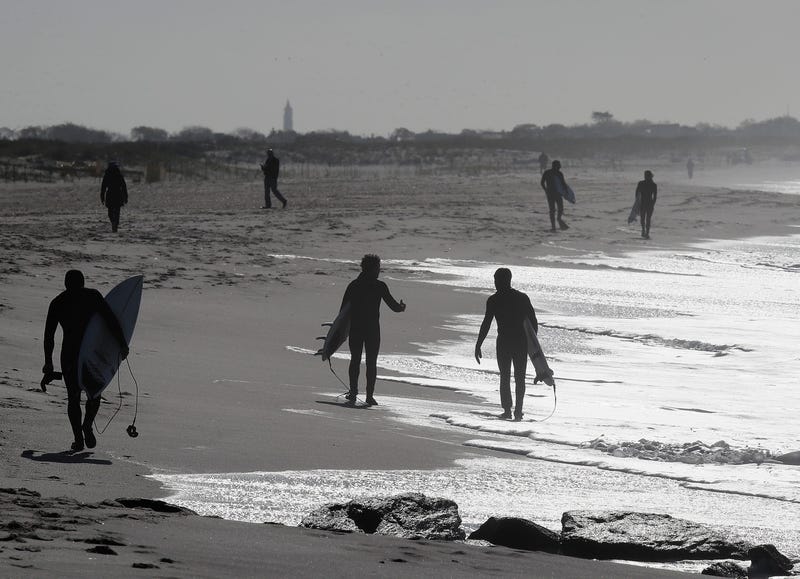 Surfers take to the water in higher than normal wave conditions on May 21, 2020 in Lido Beach, New York.