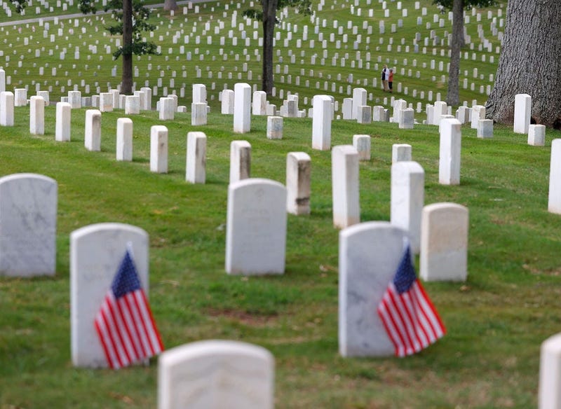 A couple stands amongst the graves in Marietta National Cemetery on Memorial Day, May 25, 2020 in Marietta, Georgia.