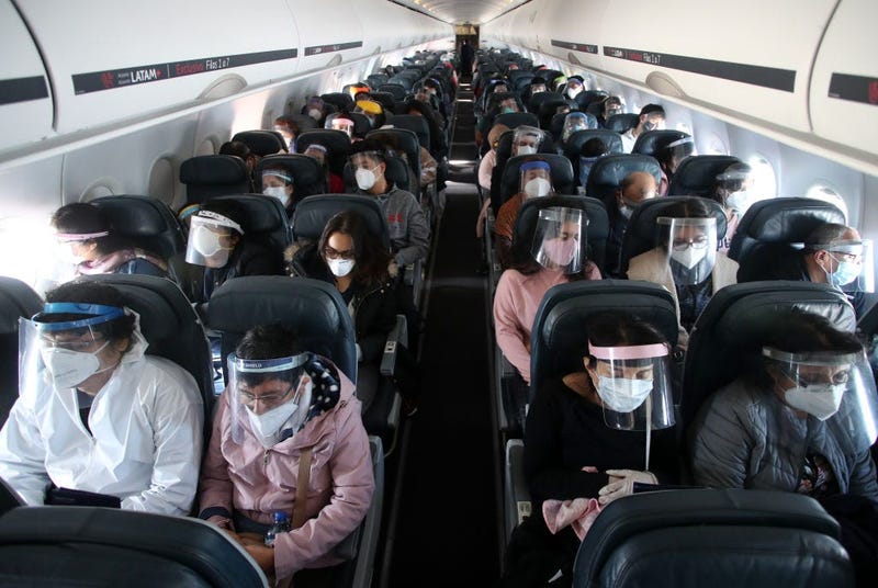 Passengers wearing face shields remain seated during the LA 2212 flight between Lima and Trujillo, Peru on July 15, 2020.