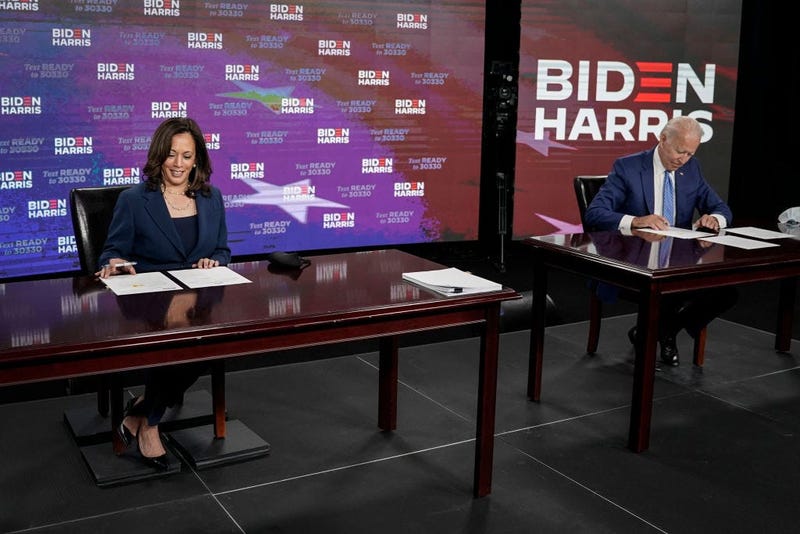 Presumptive Democratic presidential nominee former Vice President Joe Biden (R) and his running mate Sen. Kamala Harris (D-CA) sign required documents for receiving the Democratic nomination for President and Vice President