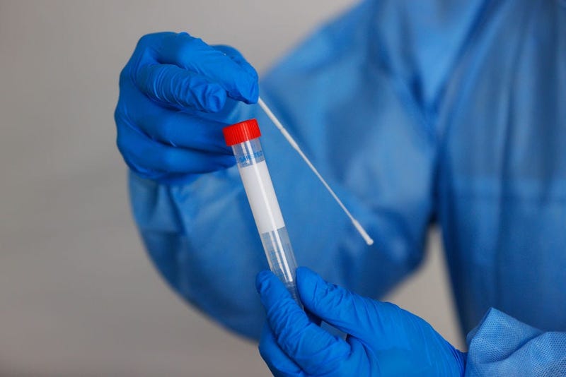 Doping Control Officer Deke Gunsolley displays a swab as he explains the coronavirus testing process at a mobile testing unit prior to the Charles Schwab Challenge on June 09, 2020 in Fort Worth, Texas.