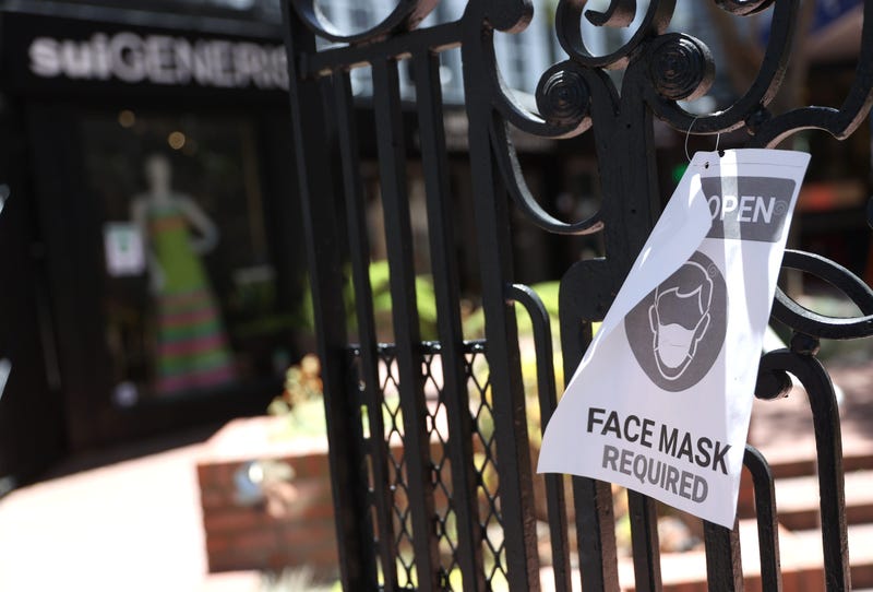 A sign alerting customers to wear a mask is posted in front of a retail store that has reopened on June 16, 2020 in San Francisco, California.