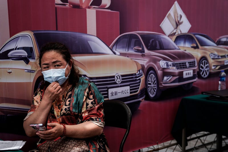 People wear face masks while visits the Auto Fair during Dragon Boat Festival holiday on June 25, 2020 in Wuhan, China.