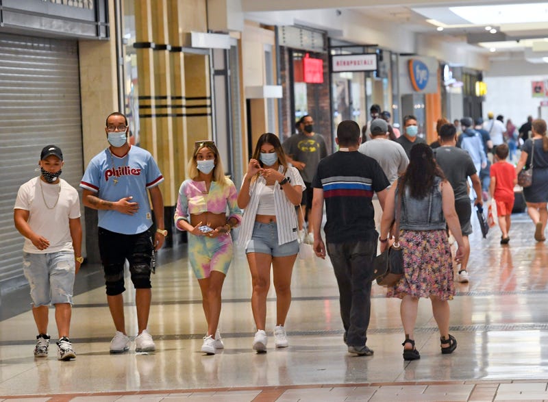 People wearing masks at mall.