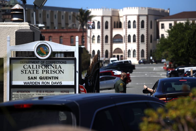 A California Department of Corrections and Rehabilitation (CDCR) officer wears a protective mask as he stands guard at the front gate of San Quentin State Prison on June 29, 2020 in San Quentin, California.