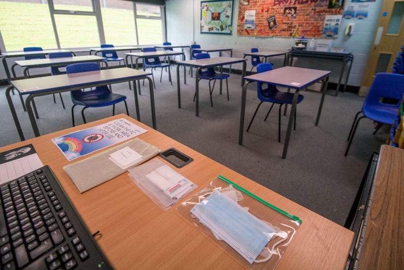 Spare face masks are seen on a teachers desk as a classroom is set out for social distancing at Longdendale High School on July 16, 2020 in Hyde, England