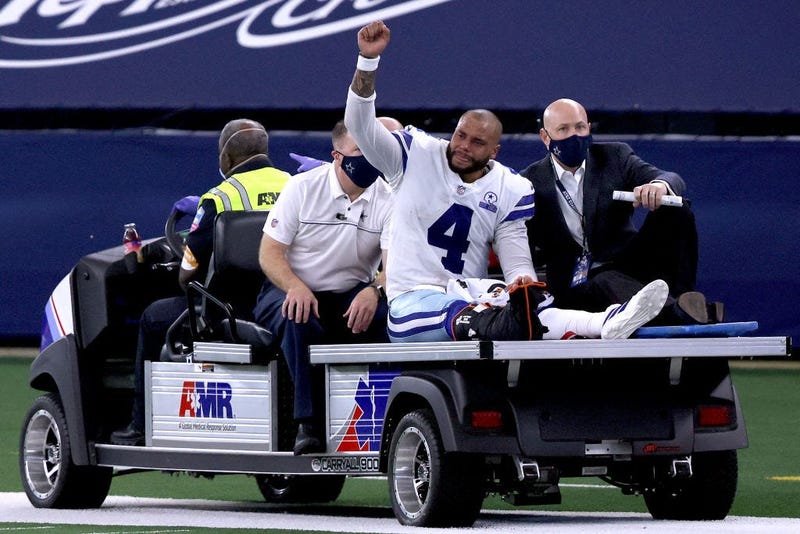 Dak Prescott #4 of the Dallas Cowboys is carted off the field after sustaining a leg injury against the New York Giants during the third quarter at AT&T Stadium on October 11, 2020 in Arlington, Texas.