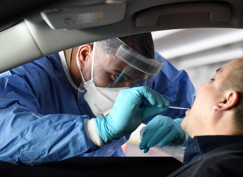 Spc. Demetrie Barnett of the Nevada National Guard administers a COVID-19 test during a preview of a free drive-thru COVID-19 testing site in the parking garage of the Texas Station Gambling Hall & Hotel on November 12, 2020 in North Las Vegas