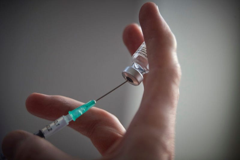 A World War II veteran receives her COVID-19 shots