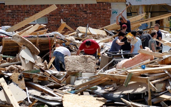 Volunteers help homeowners search through the rubble of their destroyed homes following a tornado on April 4, 2012 in Forney, Texas. Multiple tornadoes touched down yesterday across the Dallas/Fort Worth area causing extensive damage.