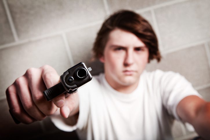 teenager male angry - pointing gun at camera