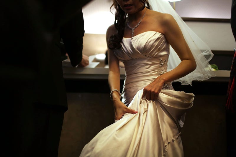 A bride waits to fill out marriage papers at a busy City Clerk's office on December 12, 2012 in New York City.