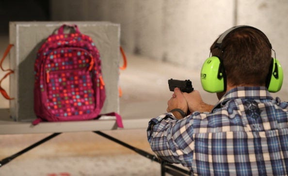 Chief Operating Officer for Amendment II, Rich Brand, shoots a child's backpack with their Rynohide CNT Shield in it on December 21, 2012 in Salt Lake City, Utah. Their orders for the bulletproof shield have gone up dramatically since the school shooting