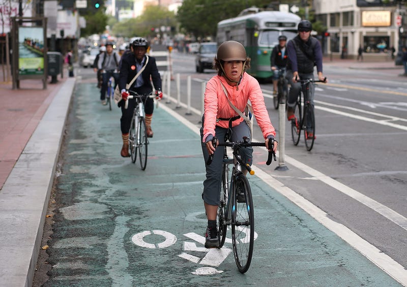 Bicyclists ride along Market Street on May 9, 2013 in San Francisco.