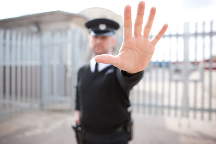 Security guard holding hand out
