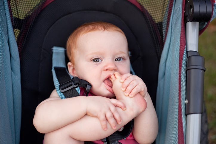 Baby Biting Their Toes