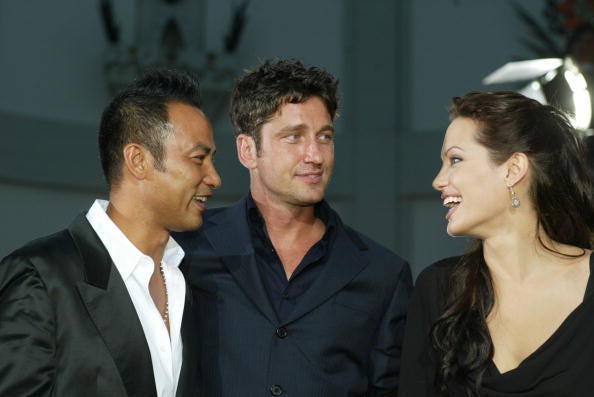 Actors Simon Yam, Gerard Butler and Angelina Jolie attend the world premiere of the film "Lara Croft Tomb Raider: The Cradle of Life" at Grauman's Chinese Theatre July 21, 2003 in Hollywood, California. The film releases nationwide July 25, 2003.