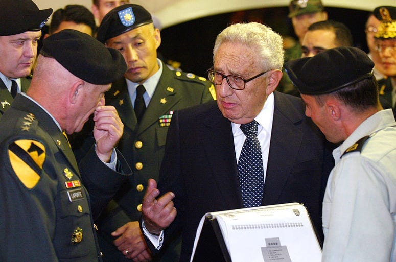 Former U.S. Secretary of State Henry Kissinger (C) talks with General Leon LaPorte (L), U.S. Forces Korea commander, during an armistice commemoration ceremony at Yongsan U.S. Army base July 27 2003 in Seoul, South Korea.