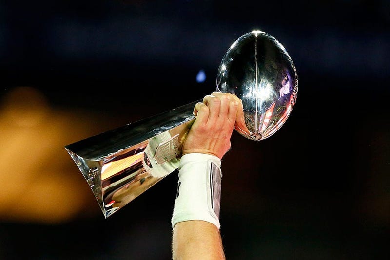 Player holds the Vince Lombardi Trophy after winning Super Bowl