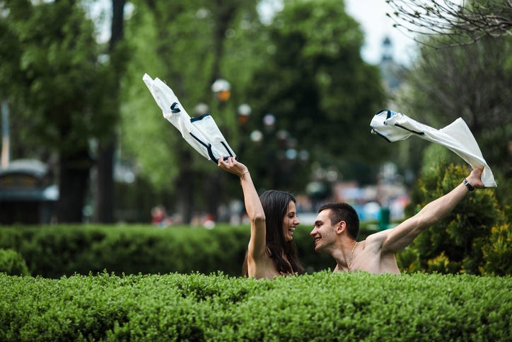 Couple undress in the city
