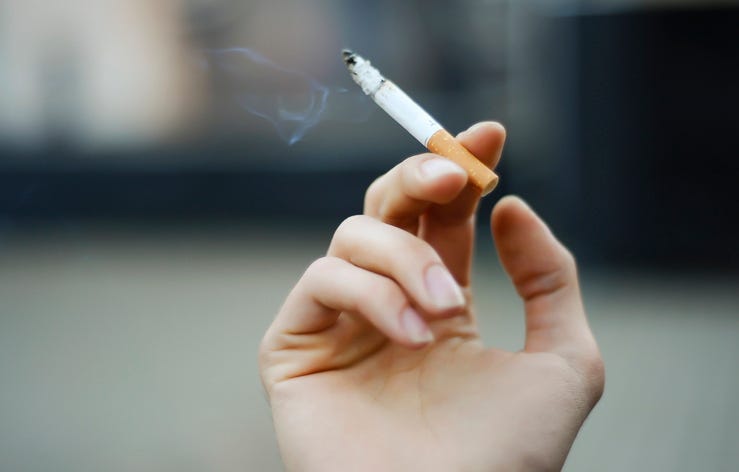 A person holding a cigarette.