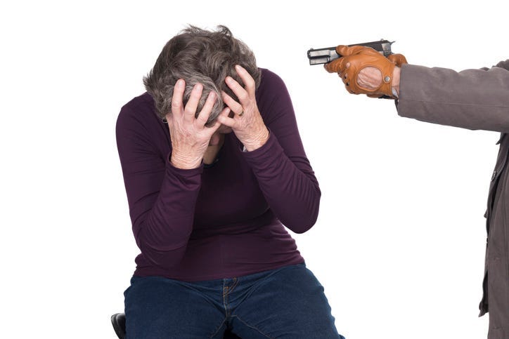 elderly woman under attack by knife or gun