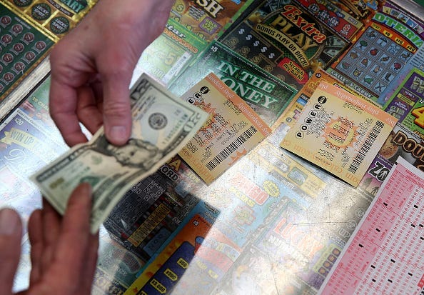 customer buys Powerball tickets at Kavanagh Liquors on January 13, 2016 in San Lorenzo, California. Dozens of people lined up outside of Kavanagh Liquors, a store that has had several multi-million dollar winners, to -purchase Powerball tickets in hopes
