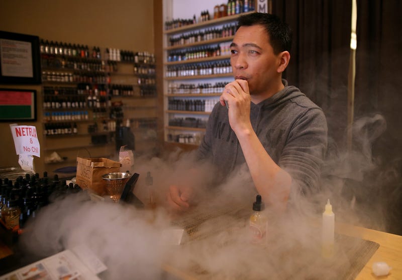 Christopher Chin blows puffs on an e-cigarette as he waits for customers at Gone With the Smoke Vapor Lounge on May 5, 2016 in San Francisco, California.