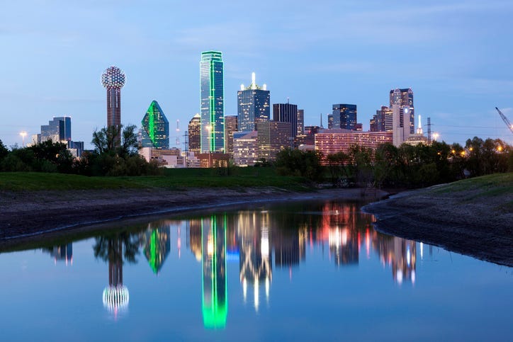 Dallas downtown skyline illuminated at night with reflection in the Trinity River. Texas, United States