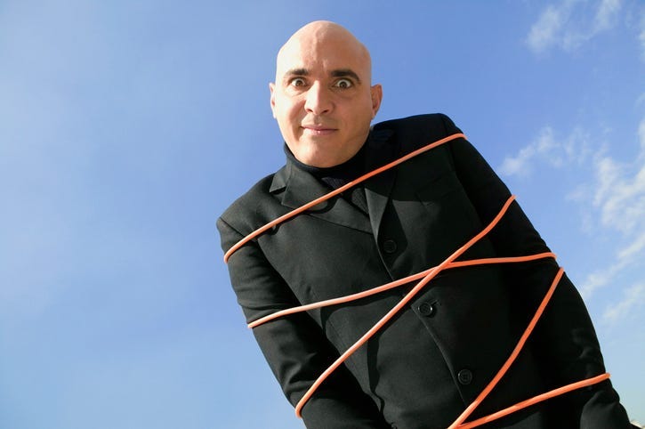 Low angle view of a mid adult man tied up in rope
