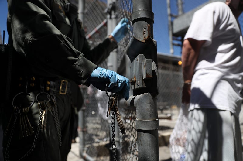 A California Department of Corrections and Rehabilitation (CDCR) officer opens the gate for a condemned inmate who is leaving the exercise yard at San Quentin State Prison's death row on August 15, 2016 in San Quentin, California.