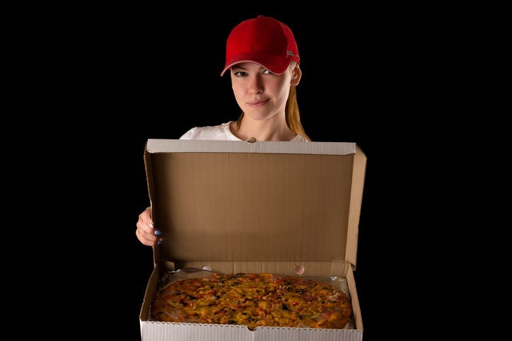 young attractive girl with a pizza box isolated on black background